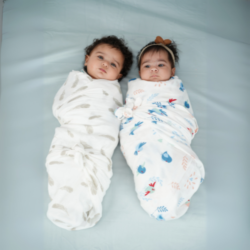 Cuddle up in Chirpy Bird Print And Feather Print Bamboo Swaddle