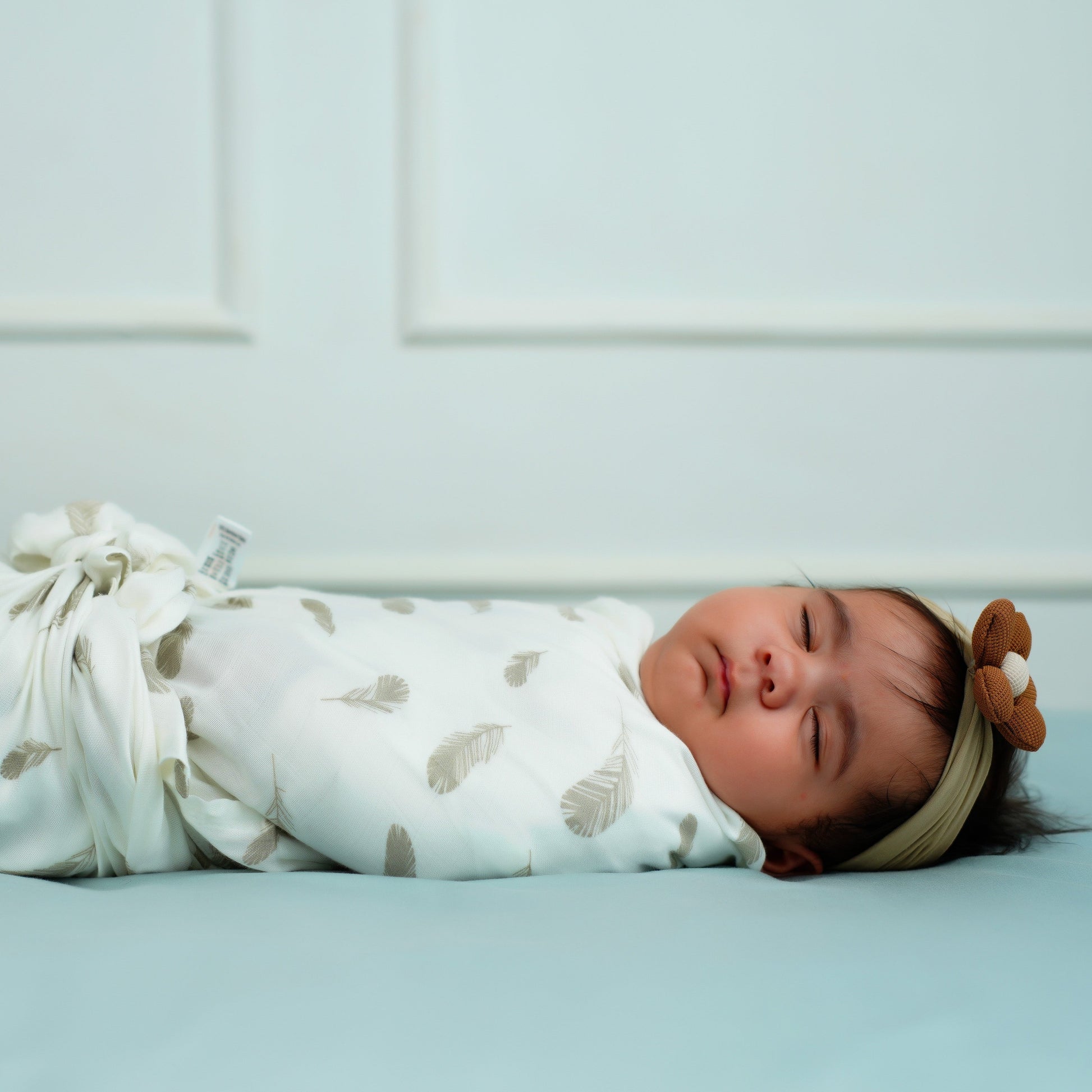 Cuddle up in Feather Print Bamboo Swaddle